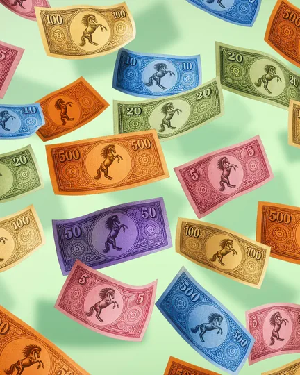 Pastel play money printed with the rearing black horse, scattered on green