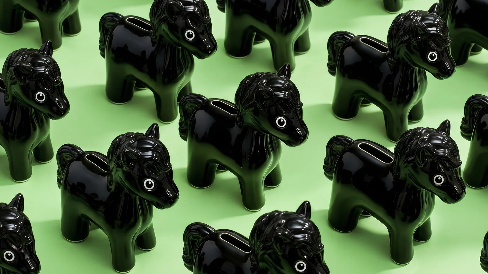 Lloyds Summer: rows of glossy black horse-shaped piggy banks on green