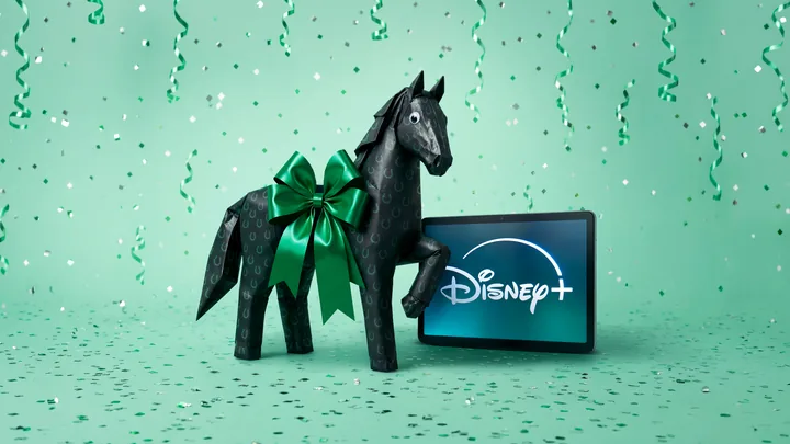 The wrapped black horse beside a tablet showing the Disney+ logo